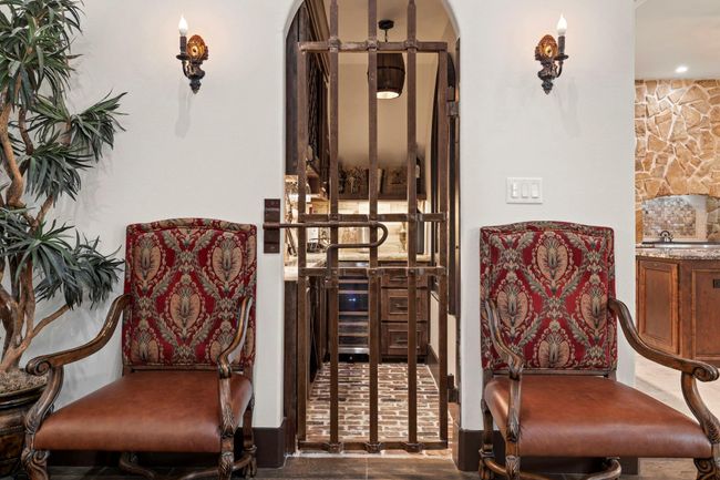 Arched iron door leading into bar/wine storage area | Image 40
