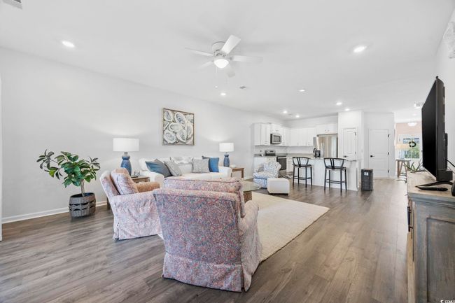 Living room featuring a ceiling fan, recessed lighting, baseboards, and dark wood finished floors | Image 14