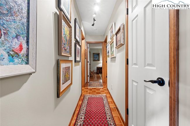 Hallway leading to the two additional bedrooms and the bath | Image 25