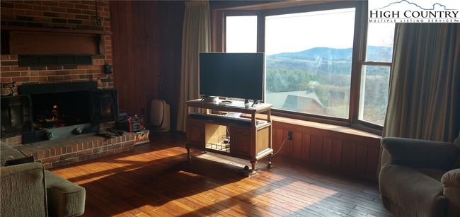 Den with fireplace and continued good views | Image 4