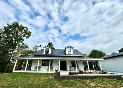 View of front of home featuring a porch and a front yard | Image 1