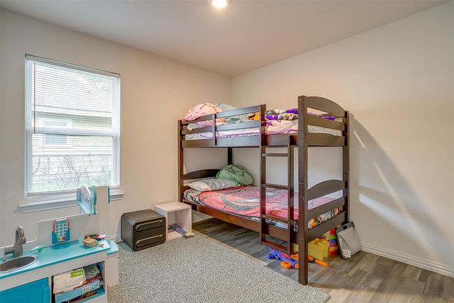 Bedroom featuring multiple windows and vinyl floors | Image 22