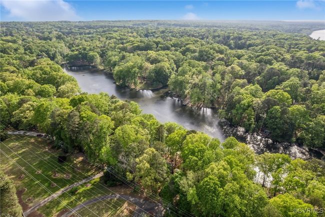 Birds eye view of property with a wooded view and a water view | Image 44