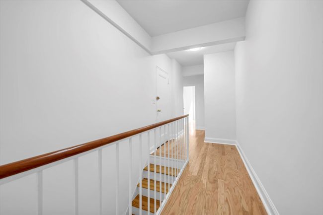 Hallway featuring light wood-type flooring and an upstairs landing | Image 10