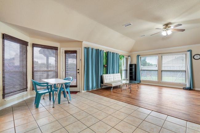 Sunroom with tile patterned flooring and vaulted ceiling | Image 19