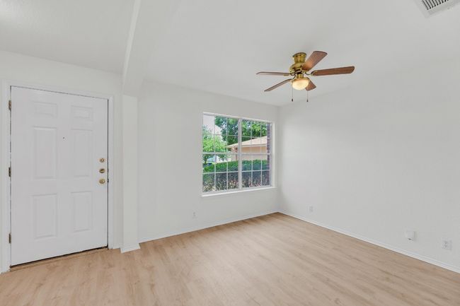 Foyer entrance featuring light wood-style floors, visible vents, a ceiling fan, and baseboards | Image 21
