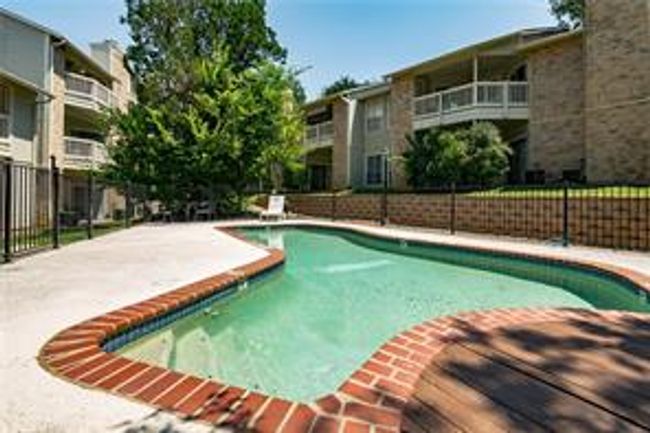 View of swimming pool featuring fence and a patio area | Image 30