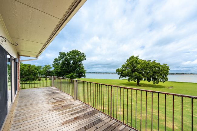 Wooden deck with a water view and a lawn | Image 22