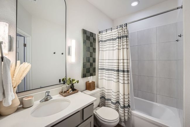 Bathroom with toilet, shower / tub combo, and vanity | Image 23