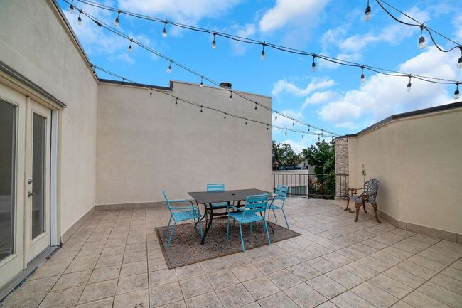 Patio/terrace featuring breathtaking outdoor dining area with string lights | Image 26