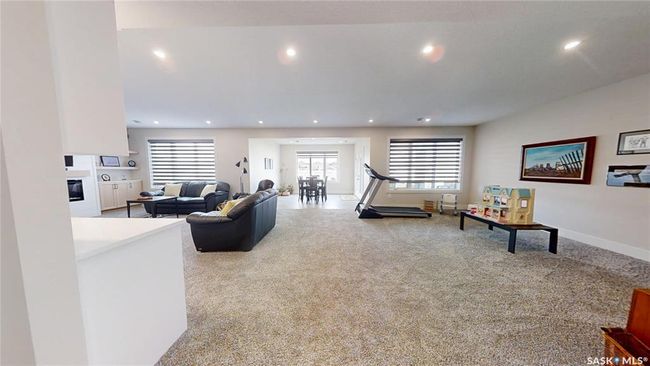 Carpeted living area featuring recessed lighting and a glass covered fireplace | Image 23