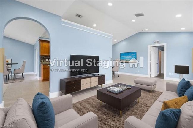Living area featuring vaulted ceiling, arched walkways, recessed lighting, and light tile patterned flooring | Image 5