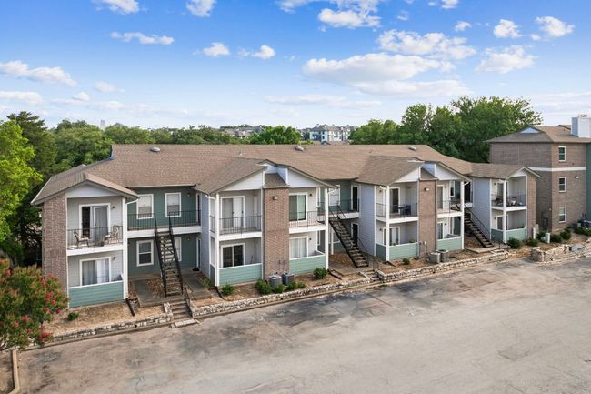 Townhome / multi-family property featuring stairway, brick siding, a balcony, and a residential view | Image 19