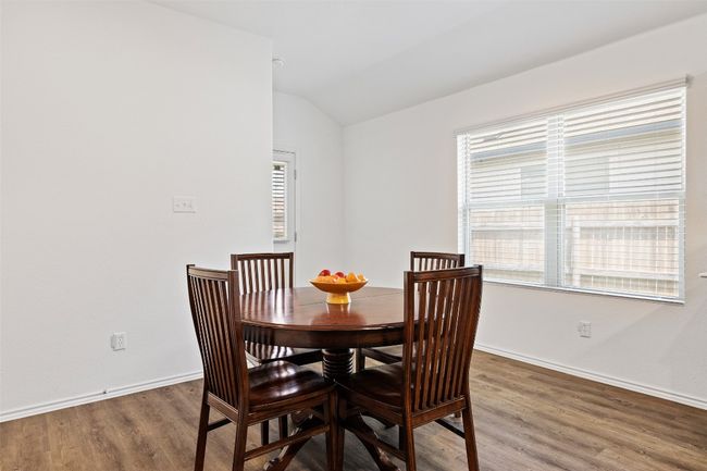 Dining space featuring lofted ceiling and wood finished floors | Image 14