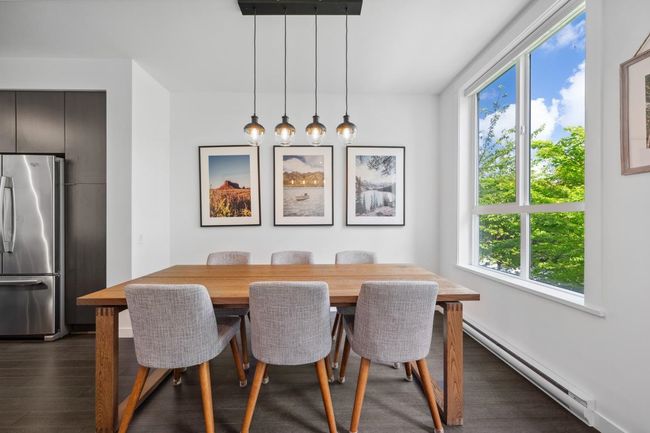 Dining space with a baseboard radiator, dark wood finished floors, and baseboards | Image 17