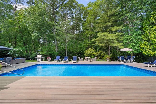 Outdoor pool with an outdoor hangout area, a deck, outdoor dining area, grilling area, and a patio | Image 25