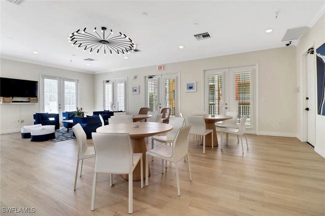 Dining room with french doors, ornamental molding, light wood finished floors, and recessed lighting | Image 19