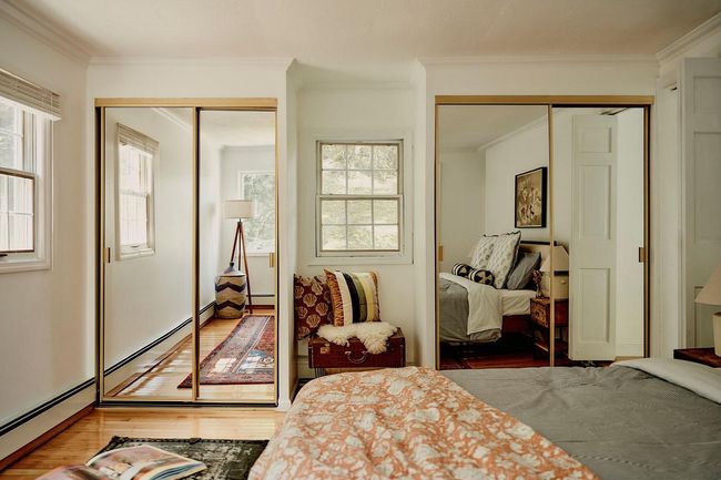 Bedroom with hardwood / wood-style flooring, two closets, crown molding, and multiple windows | Image 18