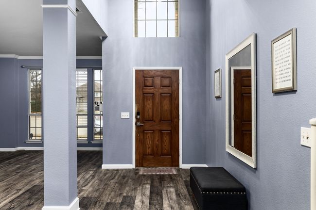 Foyer featuring dark wood-type flooring and crown molding | Image 6