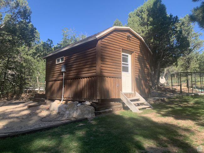 View of side of home with entry steps and a yard | Image 29