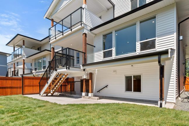 Back of property featuring a patio, stairs, and a balcony | Image 39