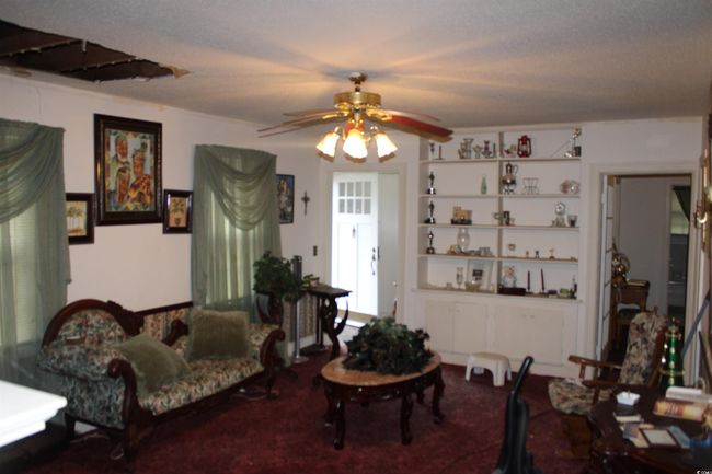 Living area featuring a ceiling fan | Image 9