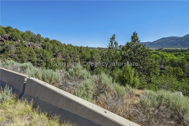 View of mountain backdrop featuring a heavily wooded area | Image 6
