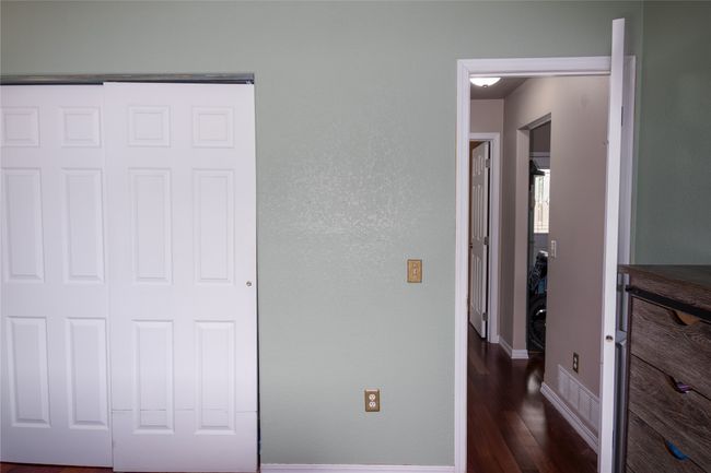 Unfurnished bedroom featuring wood finished floors, baseboards, and a closet | Image 51