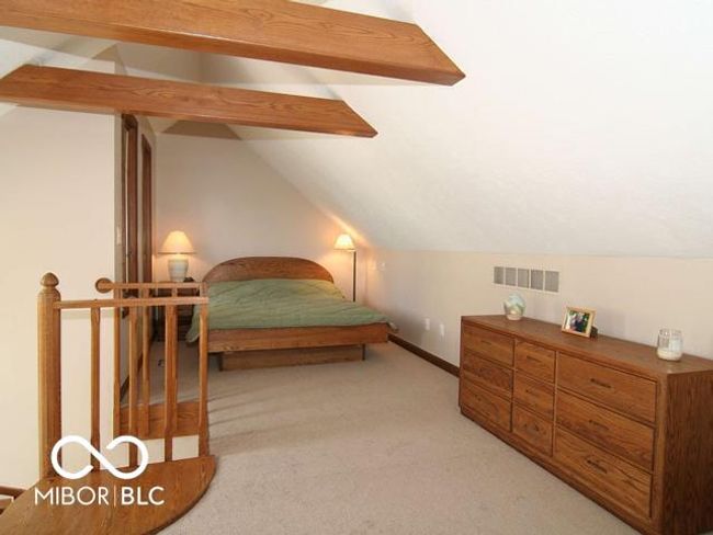 bedroom with lofted ceiling with beams, visible vents, baseboards, old pic shows the bed | Image 30