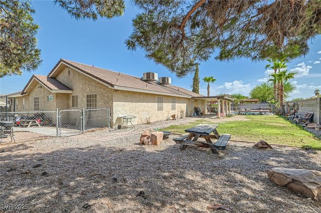 Rear view of house featuring a gate, fence, cooling unit, and stucco siding | Image 25