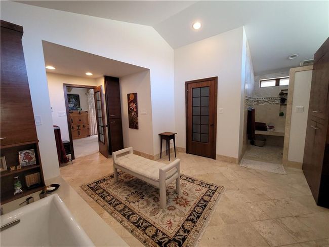 Corridor featuring baseboards, vaulted ceiling, visible vents, and recessed lighting | Image 30