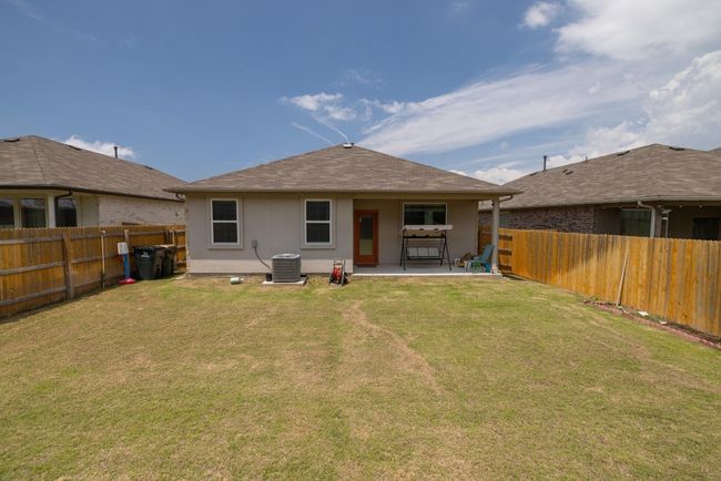 Rear view of property with stucco siding, a patio area, and roof with shingles | Image 24