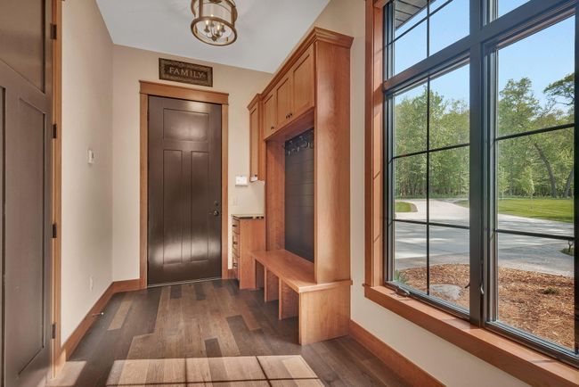 Garage entry into the home opens into a well-planned area with built ins for everyday functionality. | Image 77