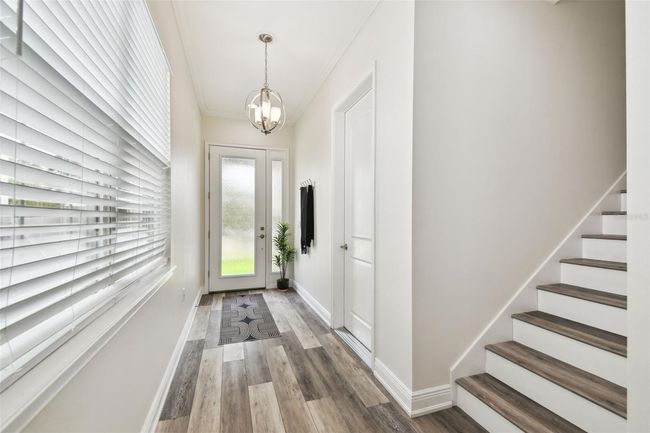 Alternate view of foyer - custom lights - blinds on each window, Luxury laminate wood looking floor throughout entire home. | Image 5