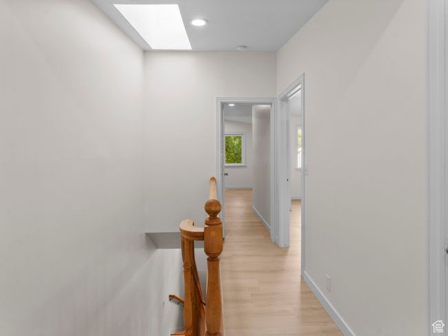 Corridor featuring light wood finished floors, a skylight, and recessed lighting | Image 14