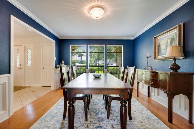 Dining space featuring ornamental molding and light wood flooring | Image 9