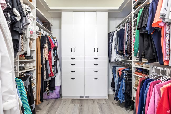 Walk in closet featuring light hardwood / wood-style flooring | Image 20