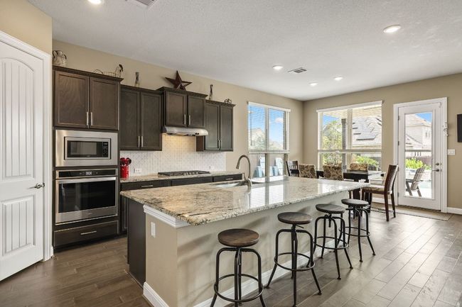View of kitchen with granite countertops and view of the outdoor space | Image 17