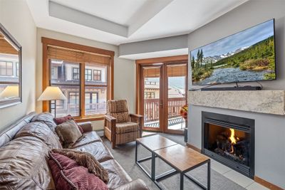 Living room featuring a tray ceiling and baseboard heating | Image 3