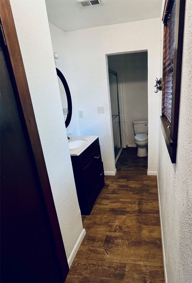 Bathroom featuring vanity, wood floors, medicine cabinet mirror and linen closet | Image 6