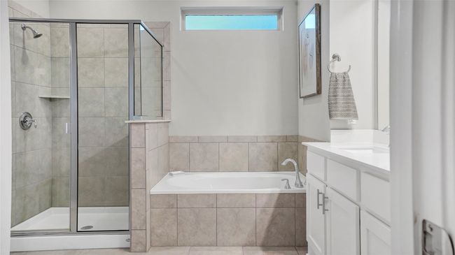 Full bath featuring vanity, a shower stall, and a garden tub | Image 19