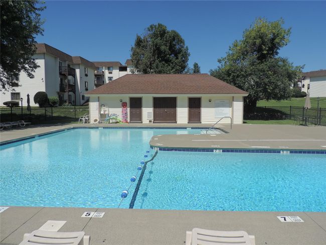 Community pool featuring fence and a patio area | Image 13