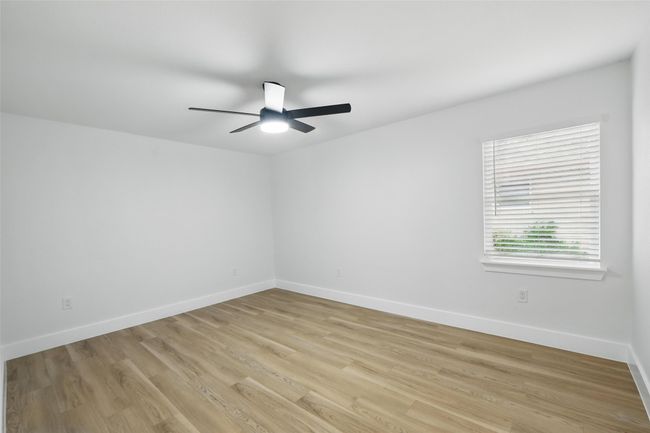 Unfurnished room featuring ceiling fan, light wood-style floors, and baseboards | Image 28