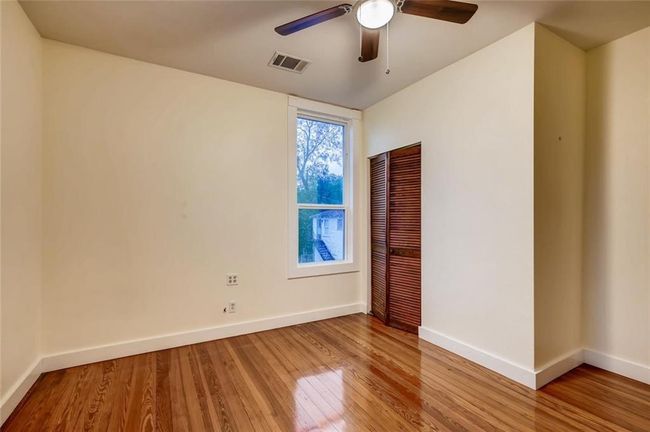Spare room featuring baseboards, light wood-type flooring, and a ceiling fan | Image 16