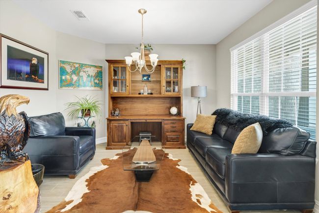 The dining room welcomes guests with an elegant light fixture for added room distinction. | Image 4