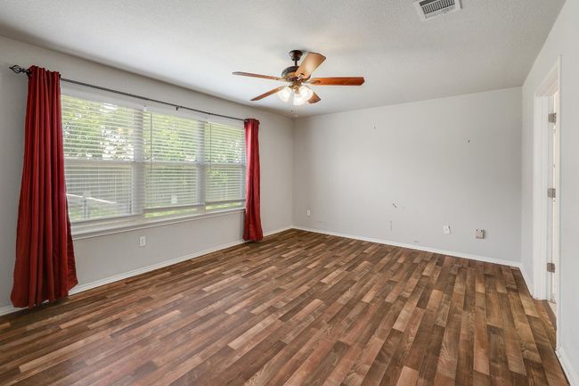 Spare room with ceiling fan and wood finished floors | Image 15