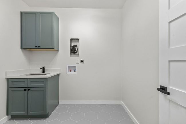 Laundry room with sink & cabinet | Image 30