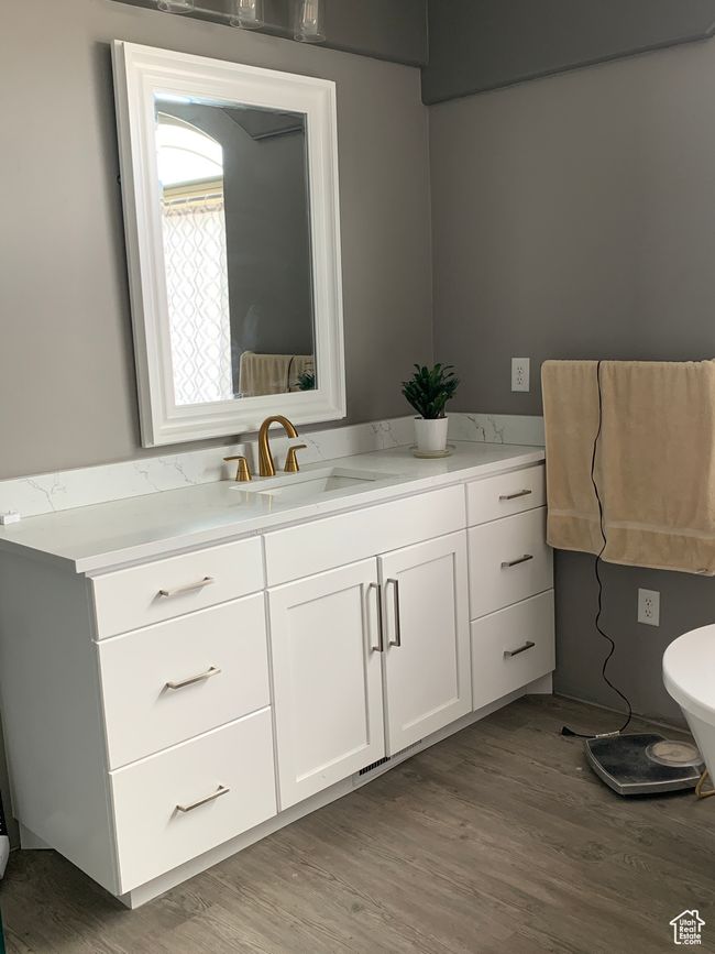 Bathroom featuring toilet, wood finished floors, and vanity | Image 14