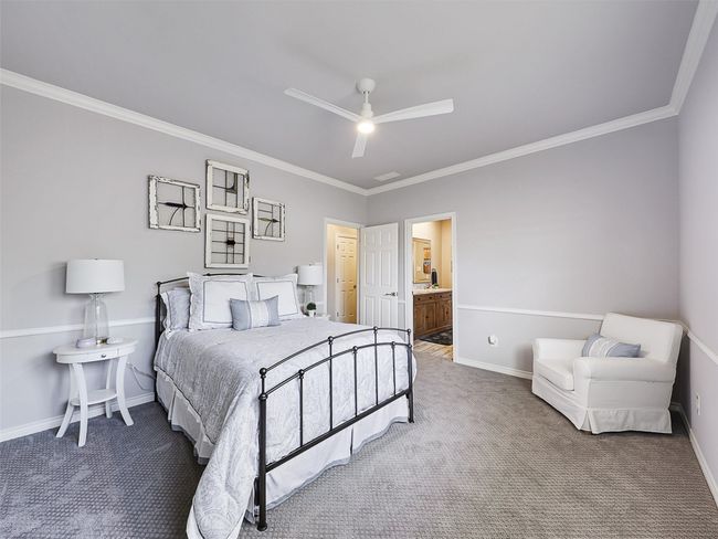 Carpeted bedroom featuring ornamental molding, a ceiling fan, and ensuite bathroom | Image 27