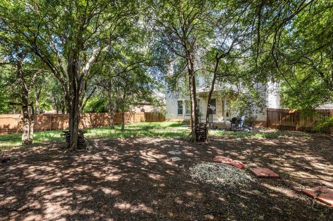 View of fenced backyard | Image 33
